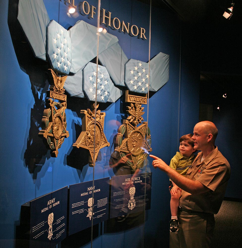 Soldier holding his kid in the museum