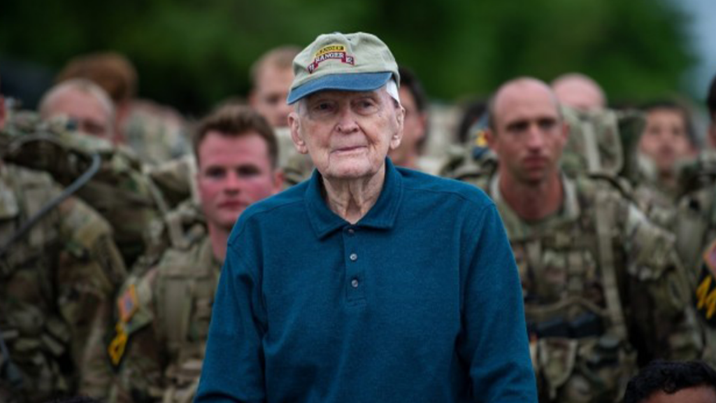 Old veteran, standing in front of young soldiers